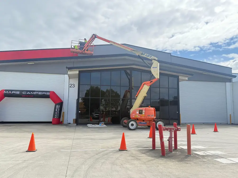 Commercial warehouse exterior repaint with scissor lift