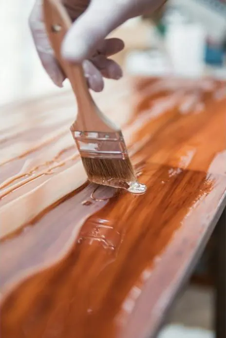 Close-up of a timber deck being freshly stained