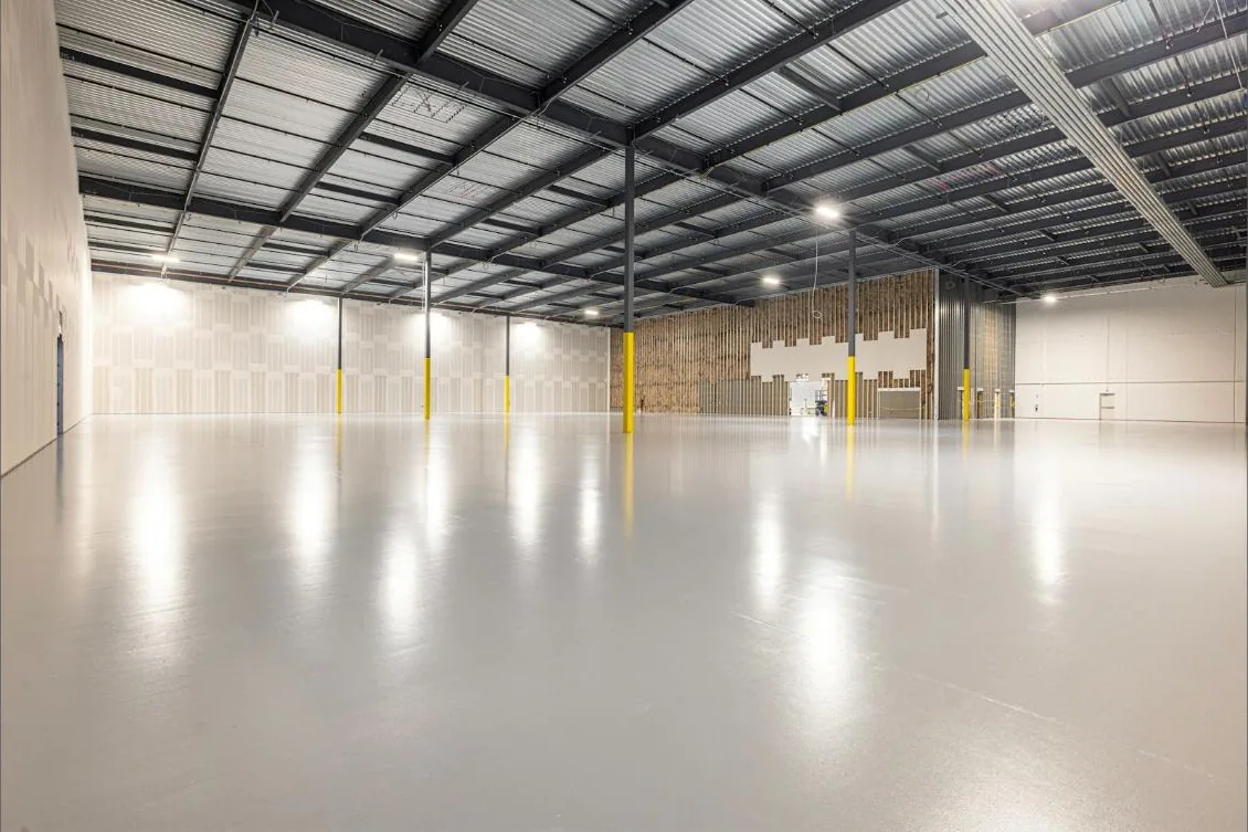 Bright, freshly coated concrete floor in a large open space