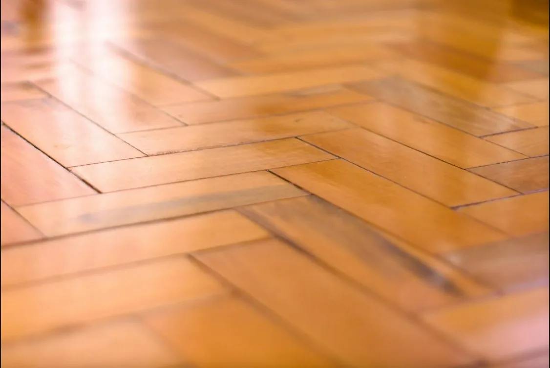 Glossy polished timber floor with herringbone pattern