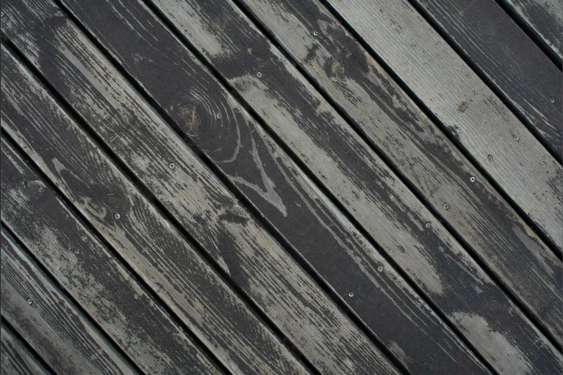 Weathered timber deck boards ready for restoration