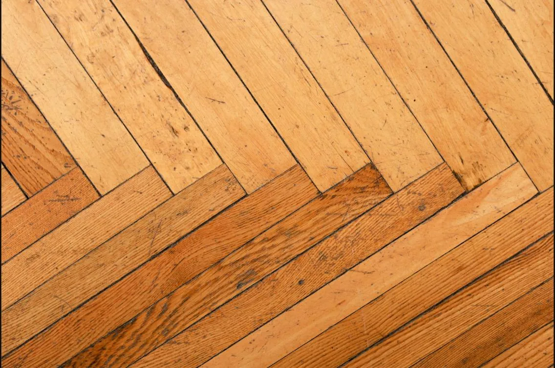 Detail of scratched parquet timber flooring before restoration